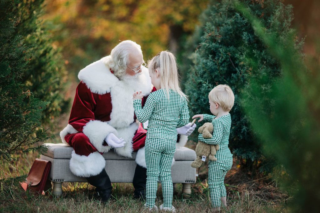 Santa with kids in pajamas at the tree farm